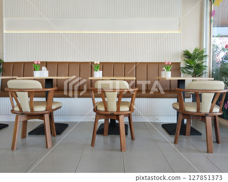 Empty wooden tables and chairs in cafe Empty wooden tables and chairs in cafe 127851373