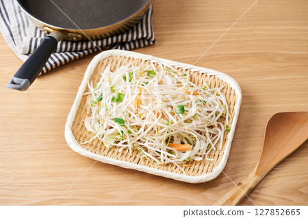 Cut vegetables arranged in a colander. Bean sprouts, pea sprouts, carrots, onions 127852665