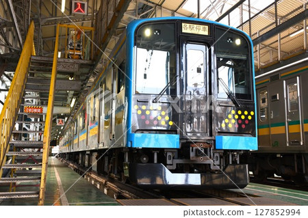 Tsurumi Line E131 series 1000 train (local train sign) parked at a depot 127852994
