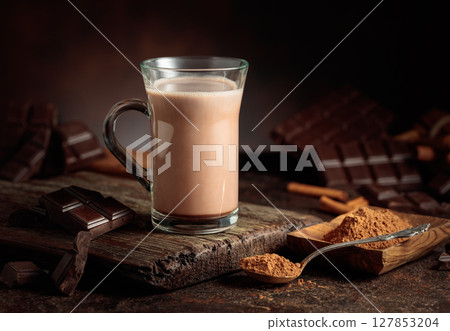 Creamy hot chocolate drink on a brown background. 127853204