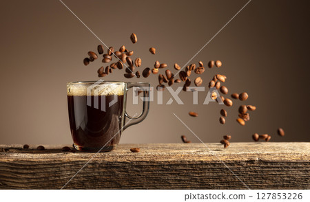 Espresso in glass cup on a old wooden table. 127853226
