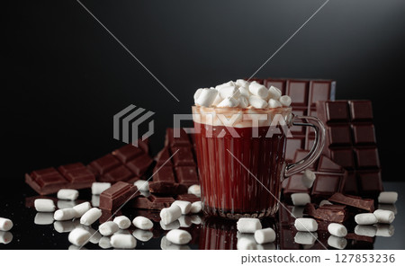 Hot chocolate with mini marshmallow in a glass mug. Hot chocolate with mini marshmallow in a glass mug. 127853236