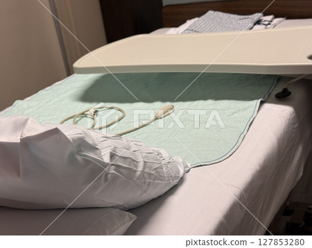 Clean Hospital Bed with Call Light and Overbed Table Clean Hospital Bed with Call Light and Overbed Table 127853280