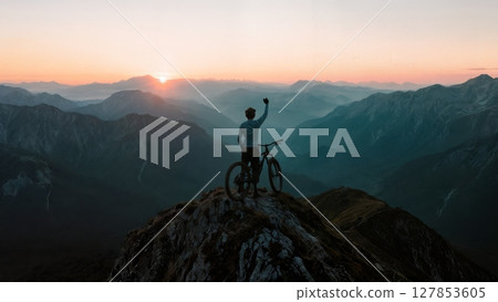 Scenic Mountain Biker on Summit, Triumph, Nature, Healthy Lifestyle. Ideal for sports brands, outdoor activities, fitness, well-being 127853605