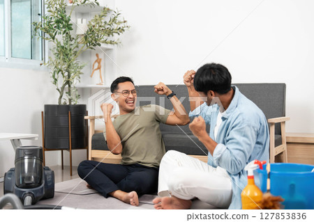 Two joyful men Celebrating Cleaning Success: Happy LGBTQIA Couple Two joyful men Celebrating Cleaning Success: Happy LGBTQIA Couple 127853836