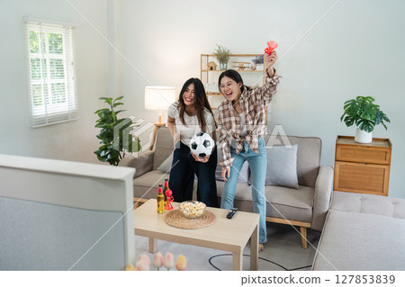 Happy football fan loudly congratulating team on winning tournament, match on tv Happy football fan loudly congratulating team on winning tournament, match on tv 127853839