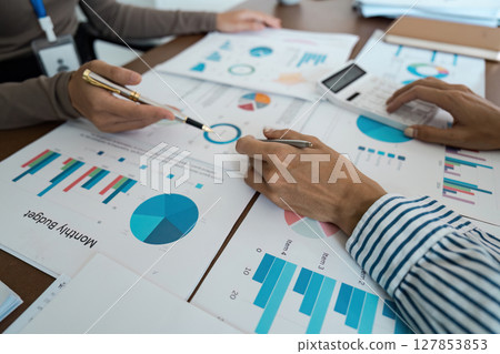 Business Team Analyzing Financial Graphs and Charts, High-Angle View Concept of financial analysis and teamwork 127853853