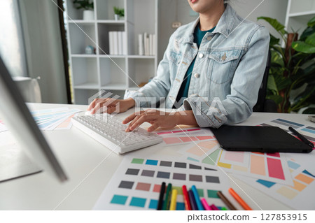 Graphic or UI designer work on computer laptop and with tablet after brainstorming unique design with professional developer UX team Graphic or UI designer work on computer laptop and with tablet after brainstorming unique design with professional developer UX team 127853915