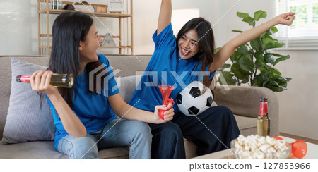 Lesbian Soccer or Sport fans emotionally watching game in the living room 127853966