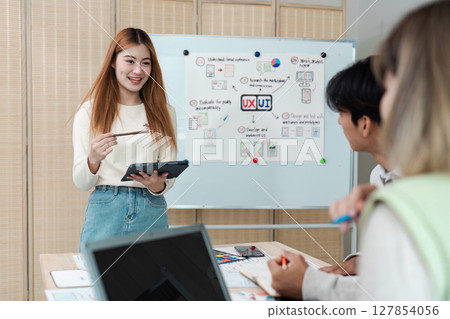 Colleagues on the conference table and discuss business, app UI and design 127854056
