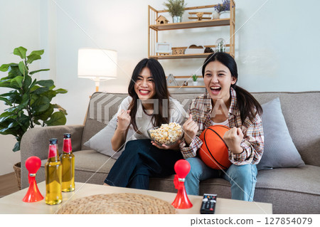 LGBT Soccer or Sport fans emotionally watching game in the living room LGBT Soccer or Sport fans emotionally watching game in the living room 127854079
