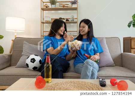 LGBT Soccer fans emotionally watching game in the living room 127854194