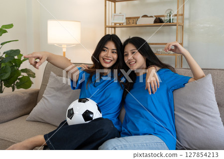LGBT Soccer fans emotionally watching game in the living room 127854213