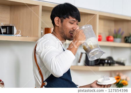 LGBT Couple Enjoying Healthy Drink in Modern Kitchen 127854396