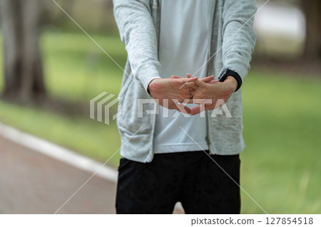 Father and Son Stretching. Emphasizing wellness through physical activity. Father and Son Stretching. Emphasizing wellness through physical activity. 127854518