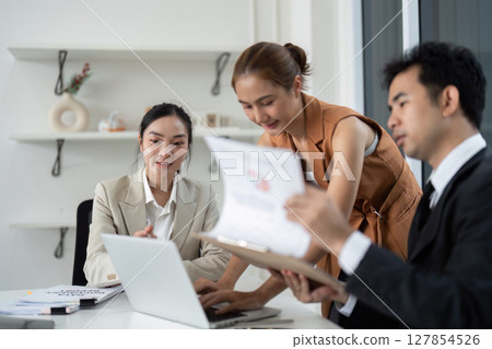 Business Collaboration and Teamwork. Professionals discussing project details in modern office. 127854526