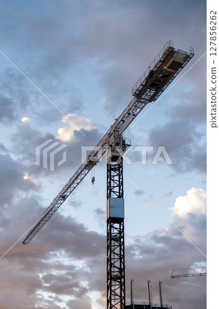 Construction crane with beautiful sunrise sky. Construction crane with beautiful sunrise sky. 127856262