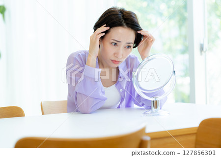 Middle-aged women who care about their hairline Middle-aged women who care about their hairline 127856301