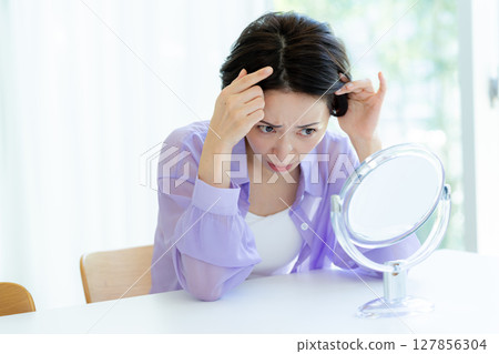 Middle-aged women who care about their hairline Middle-aged women who care about their hairline 127856304