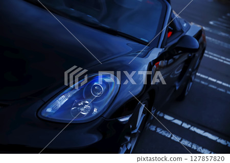 Headlights of a black convertible 127857820