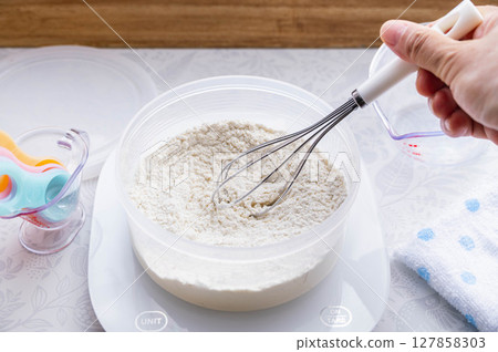 Mixing high hydration bread dough Mixing high hydration bread dough 127858303