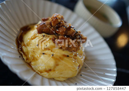 Scrambled eggs with fried chicken and savory sauce Scrambled eggs with fried chicken and savory sauce 127858447