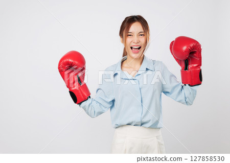 Boxing fitness and Asian young woman strength shown in a business-ready smile. Guarding with purpose, she blends red boxing mindset and modern lifestyle. isolated studio white background Boxing fitness and Asian young woman strength shown in a business-ready smile. Guarding with purpose, she blends red boxing mindset and modern lifestyle. isolated studio white background 127858530