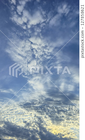 Dark blue sky with clouds over trees and water surface. Evening sunset. Dark blue sky with clouds over trees and water surface. Evening sunset. 127858621