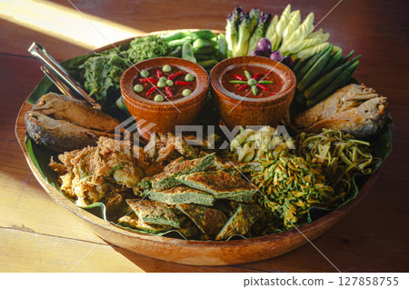 Traditional Thai food platter with fried fish and vegetables 127858755