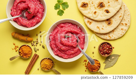 Vibrant beetroot hummus with naan and spices on yellow background for culinary design Vibrant beetroot hummus with naan and spices on yellow background for culinary design 127859209