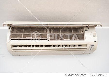 Dirty in dust and mold air conditioner filter close-up. Home air conditioner maintenance 127859429