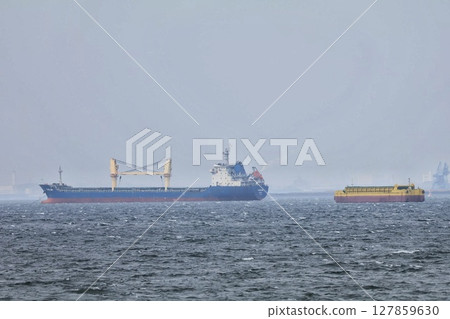Cargo ship anchored offshore Cargo ship anchored offshore 127859630