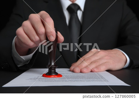 Professional Clerical Worker Stamping Important Document on Desk with Wax Seal and Paper 127860005