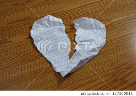 Crumpled Paper Heart Symbolizing Stress and Frustration from Negative Emotions and Heartbreak Crumpled Paper Heart Symbolizing Stress and Frustration from Negative Emotions and Heartbreak 127860011