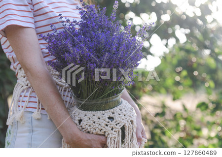 girl holding a vase of lavender 127860489