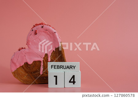 14 February calendar date Delicious fresh croissant topped with colorful flavor Ganache. Creation unique heart shape bakery. Puff pastry holiday love gift present idea Valentine's day 14 February calendar date Delicious fresh croissant topped with colorful flavor Ganache. Creation unique heart shape bakery. Puff pastry holiday love gift present idea Valentine's day 127860578