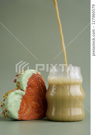 Nutrient-rich matcha drink with Green latte Matcha tea coffee with Delightful and vibrant heartshaped pastry croissant treat, beautifully topped with colorful frosting nut galore. Mock up template Nutrient-rich matcha drink with Green latte Matcha tea coffee with Delightful and vibrant heartshaped pastry croissant treat, beautifully topped with colorful frosting nut galore. Mock up template 127860579