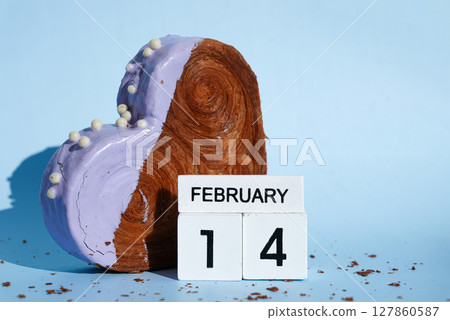 Valentine's Day 14 February wooden calendar cubes wishes greeting holiday card Heartshaped pastry croissant treat topped with colorful frosting galore. Food experimentation viral dessert baking trend 127860587