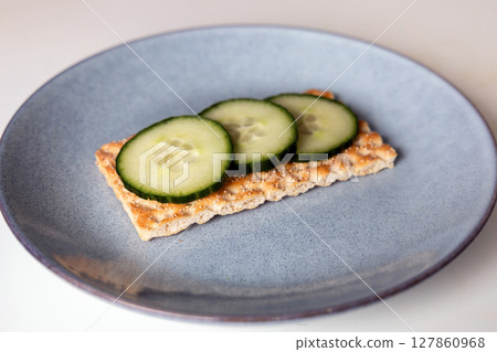 Crispbread with cucumbers on a plate Crispbread with cucumbers on a plate 127860968