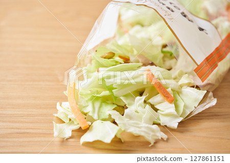 Open bag of cut vegetables (cabbage, mushrooms, carrots) 127861151