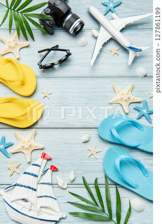 Summer vacation accessories forming a frame on wooden background 127861199