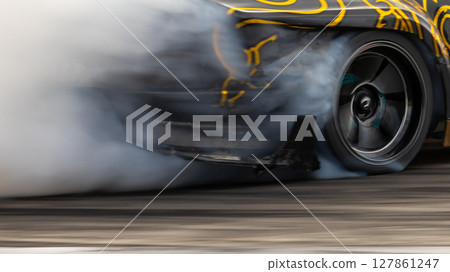 Car drifting, Blurred image diffusion race drift car with lots of smoke from burning tires on speed track, Car drifting on speed track, Professional driver driv drifting car. Car drifting, Blurred image diffusion race drift car with lots of smoke from burning tires on speed track, Car drifting on speed track, Professional driver driv drifting car. 127861247