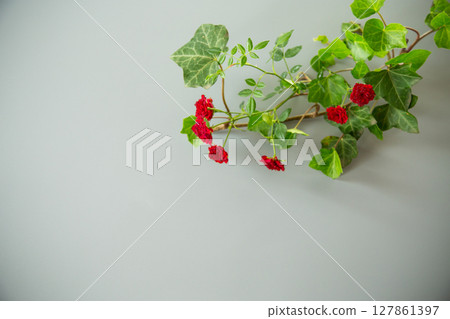 Floral arrangement of miniature red roses from above on gray background 127861397