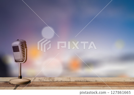 Vintage microphone on wooden table with blurred bokeh lights background Vintage microphone on wooden table with blurred bokeh lights background 127861665