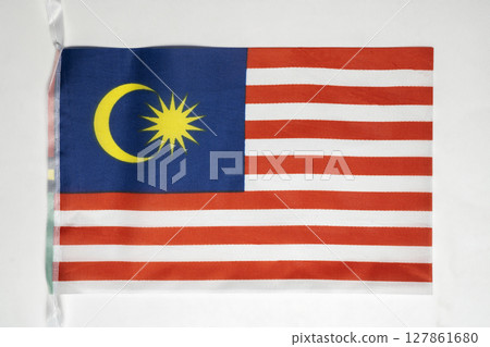 Closeup view of the Malaysia national flag isolated over a white background. Concept of government and nationality 127861680