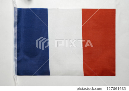 Closeup view of the France national flag isolated over a white background. Concept of government and nationality Closeup view of the France national flag isolated over a white background. Concept of government and nationality 127861683