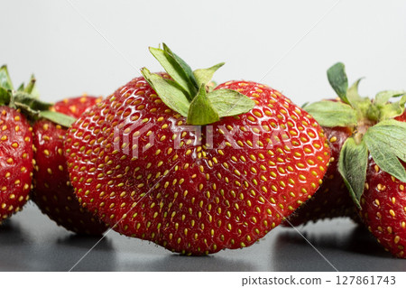 Fresh strawberries with an unusual shape close-up Fresh strawberries with an unusual shape close-up 127861743