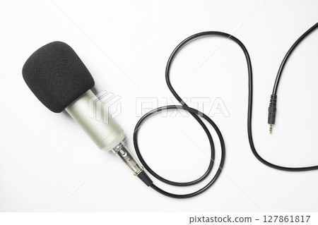 Studio microphone for podcasting or streaming with connected cable on a white background. Top view Studio microphone for podcasting or streaming with connected cable on a white background. Top view 127861817