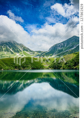 Summer in Tateyama, the blue sky and clouds reflected in the tranquil Mikurigaike pond 127861929