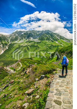 Summer in Tateyama: green plateau and majestic mountain ranges Summer in Tateyama: green plateau and majestic mountain ranges 127861932